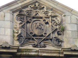 Photo of a external stone relief showing the year 1887